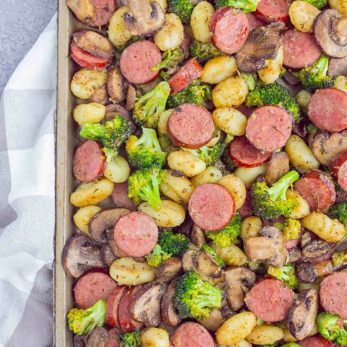 sausage, gnocchi, broccoli and mushrooms on a sheet pan