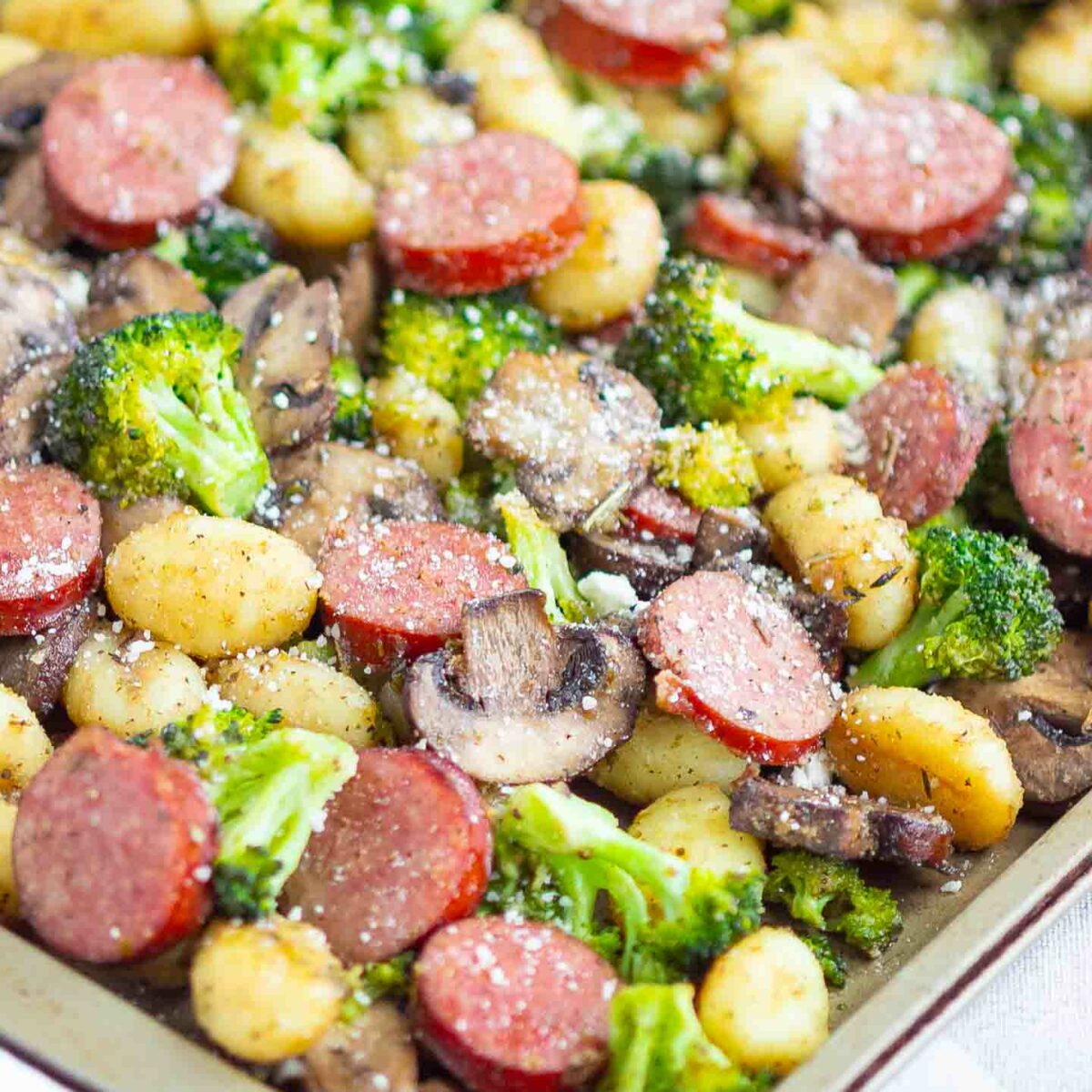 sausage, gnocchi, broccoli and mushrooms on a sheet pan
