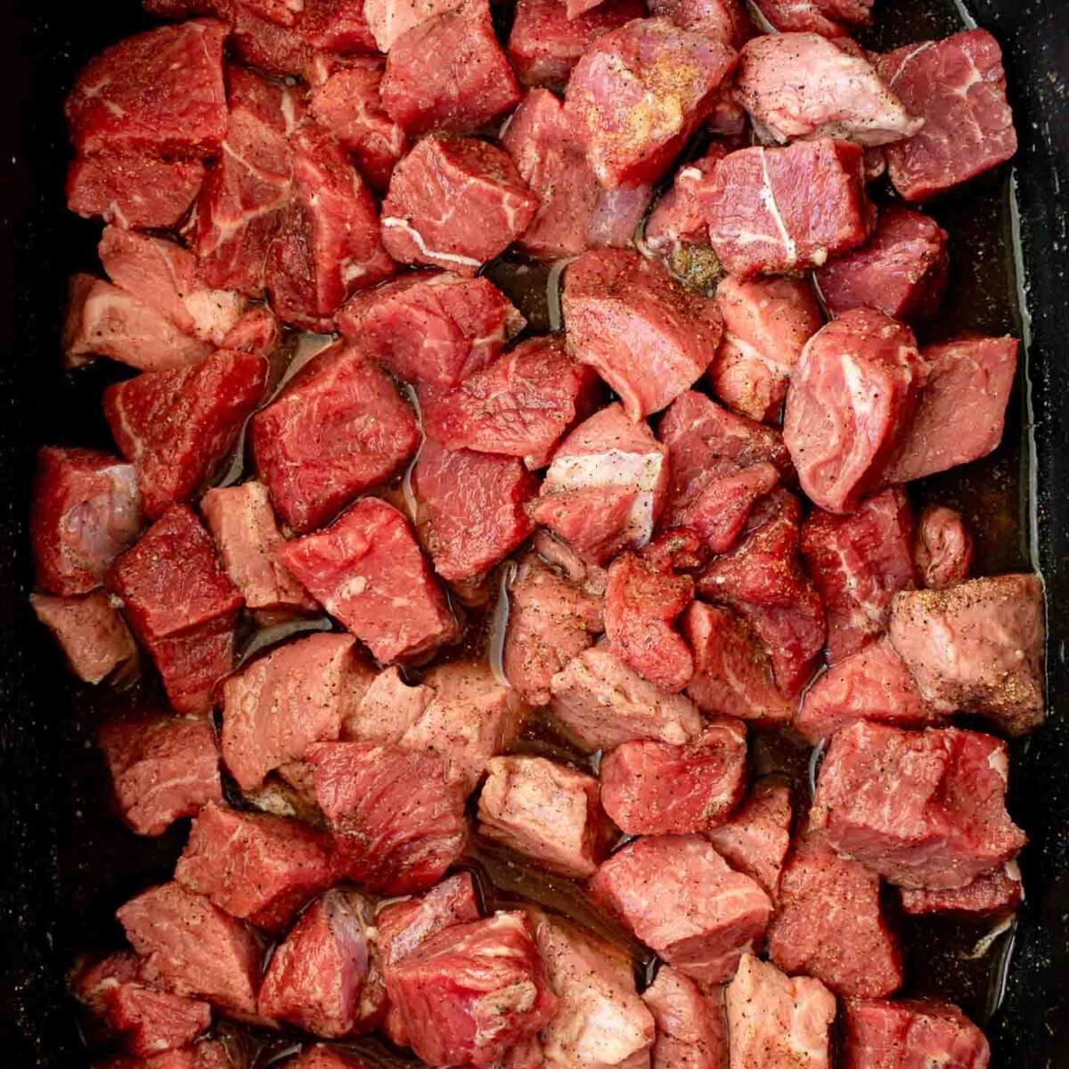 raw steak bites in the slow cooker