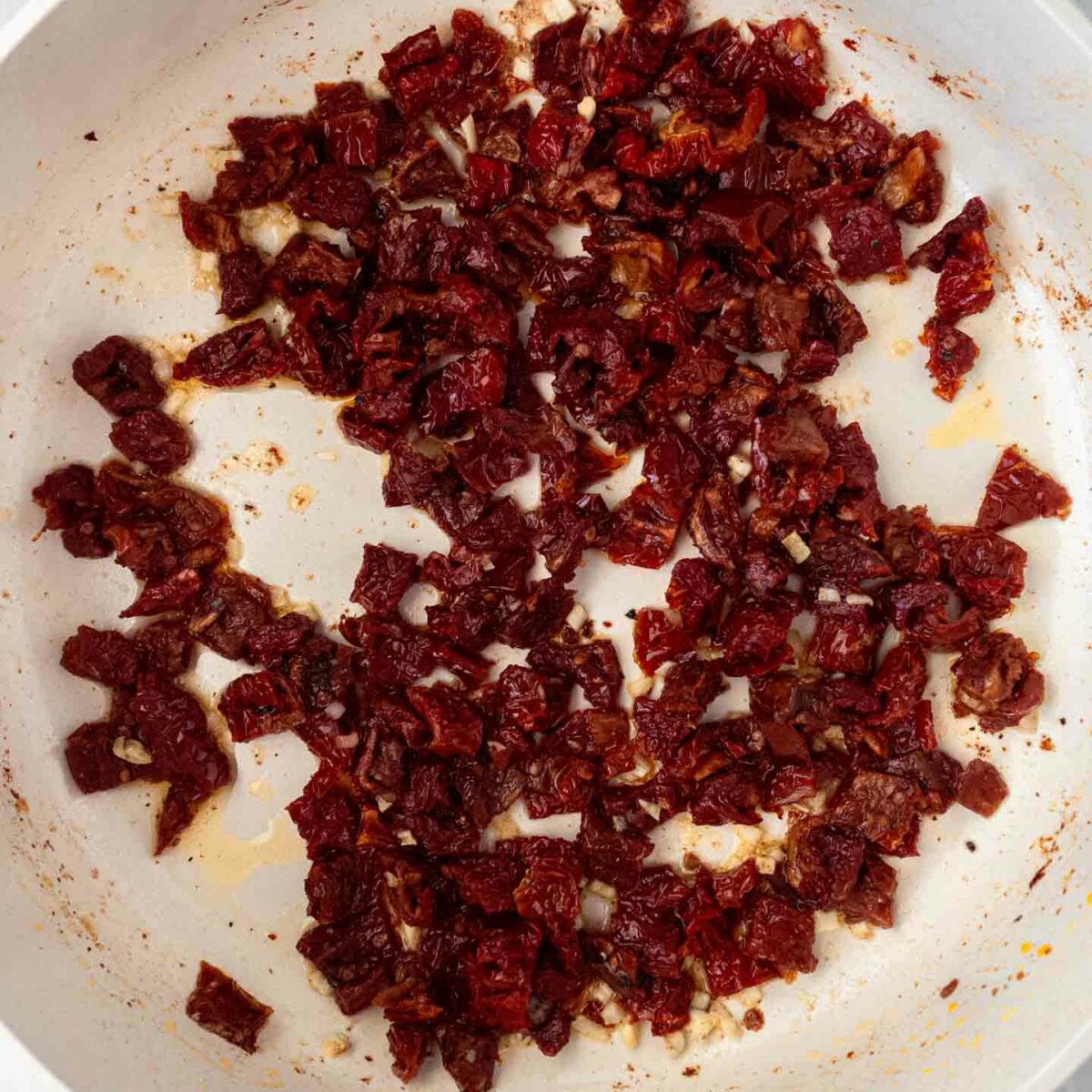 sun-dried tomatoes, milk, and spices added to skillet