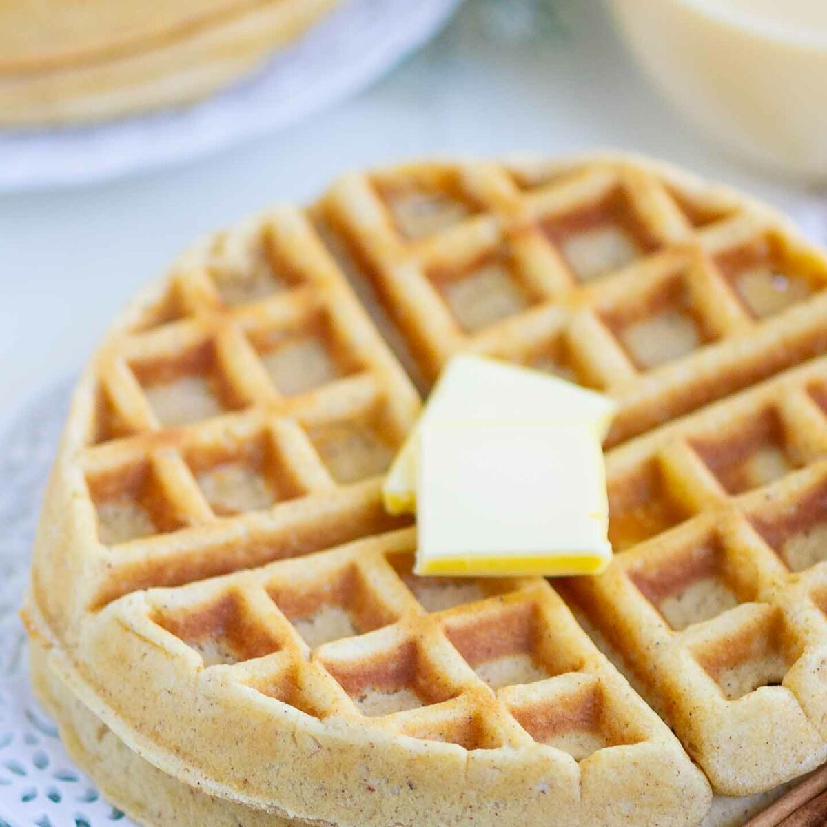 waffles with butter on a white plate