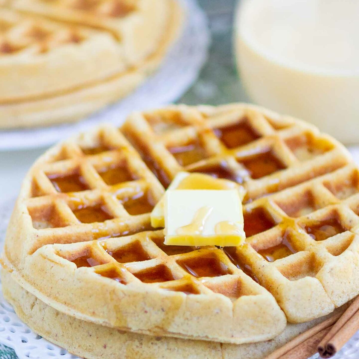 waffles with butter and syrup on a white plate