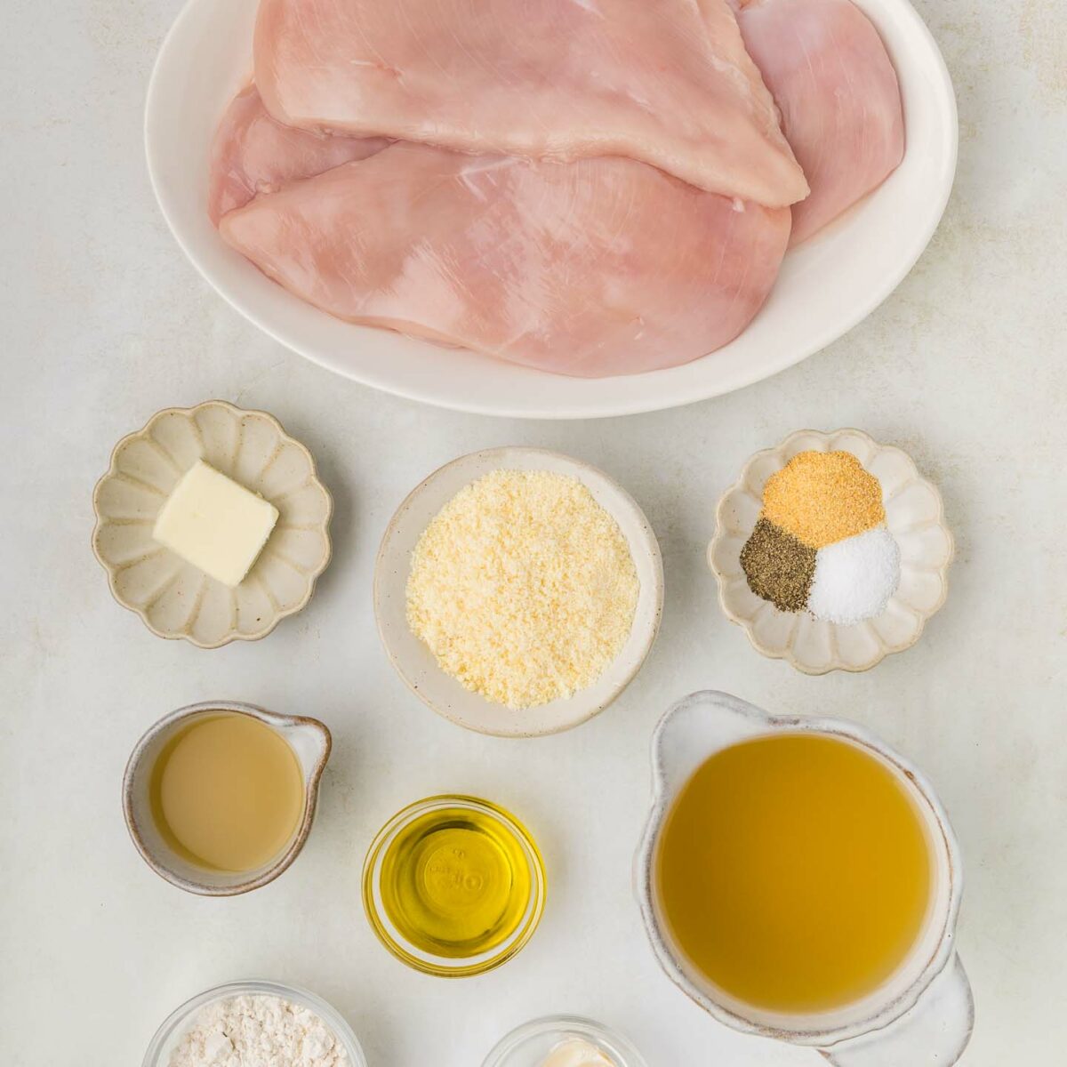 ingredients for chicken in white bowls