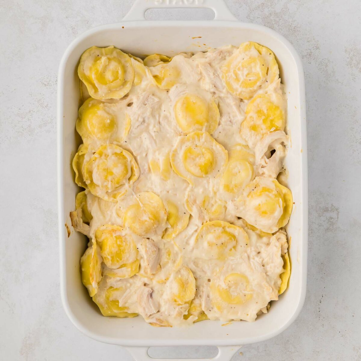 ravioli and chicken layered with alfredo sauce