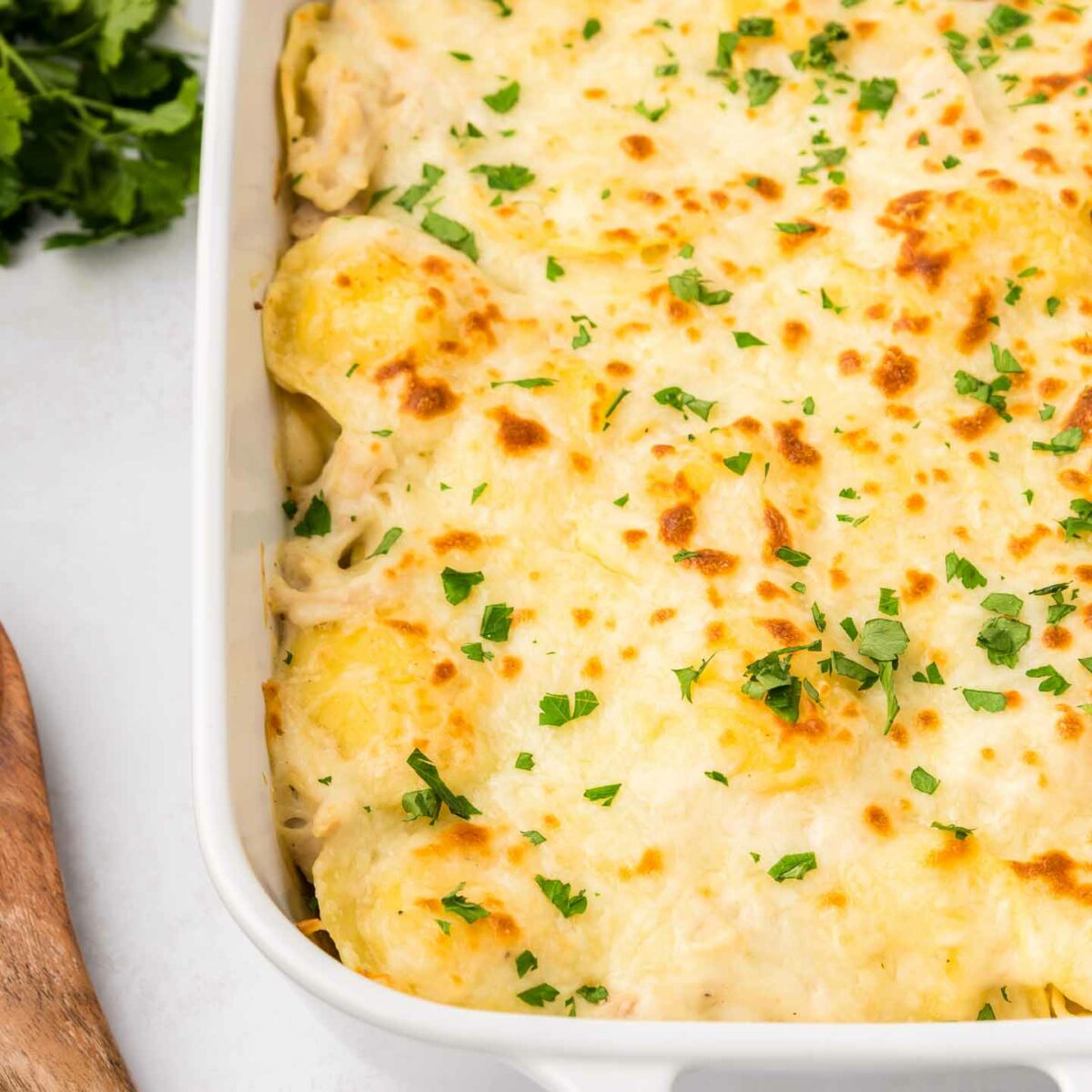 baked ravioli shown in a white dish