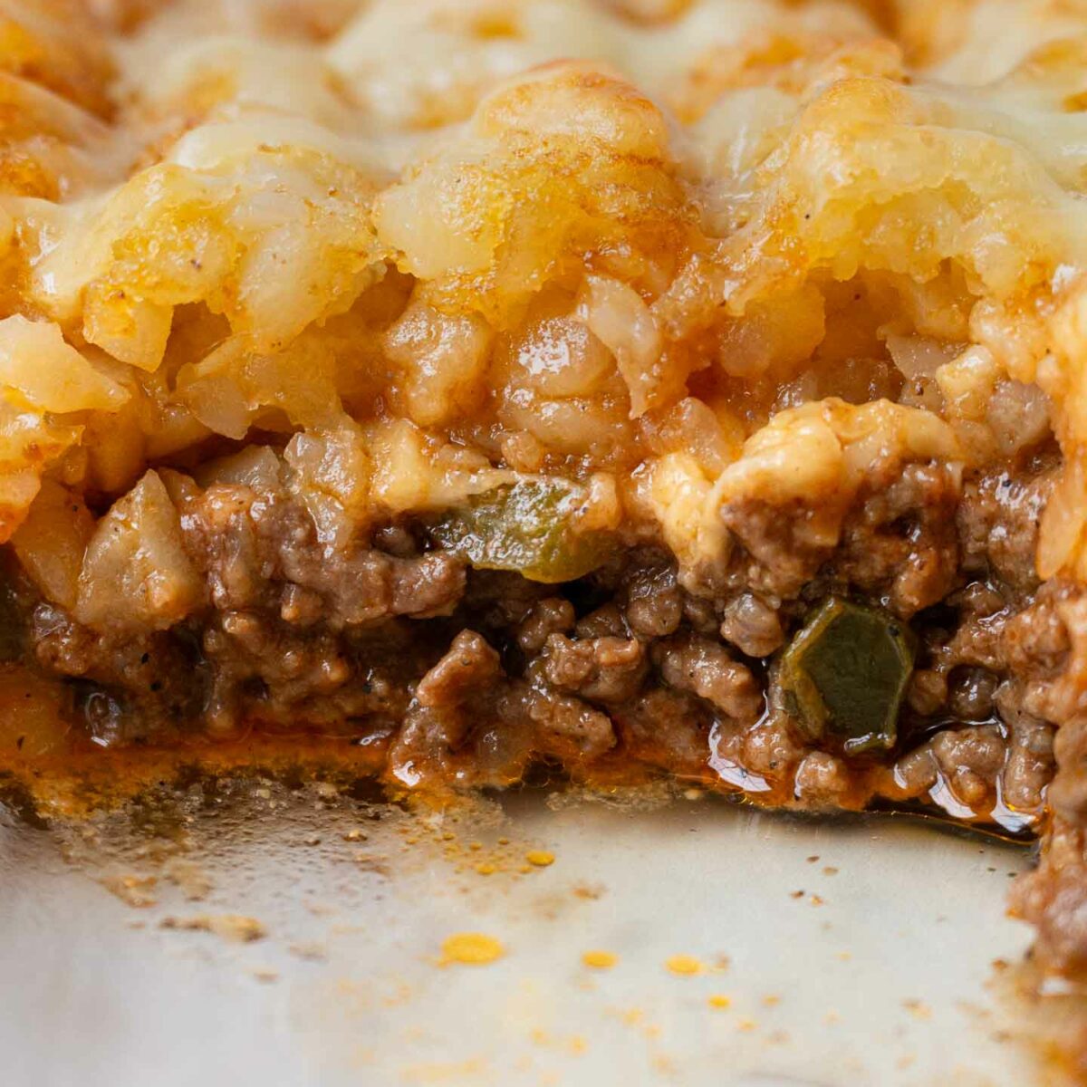casserole in a dish with a piece taken out to show the filling