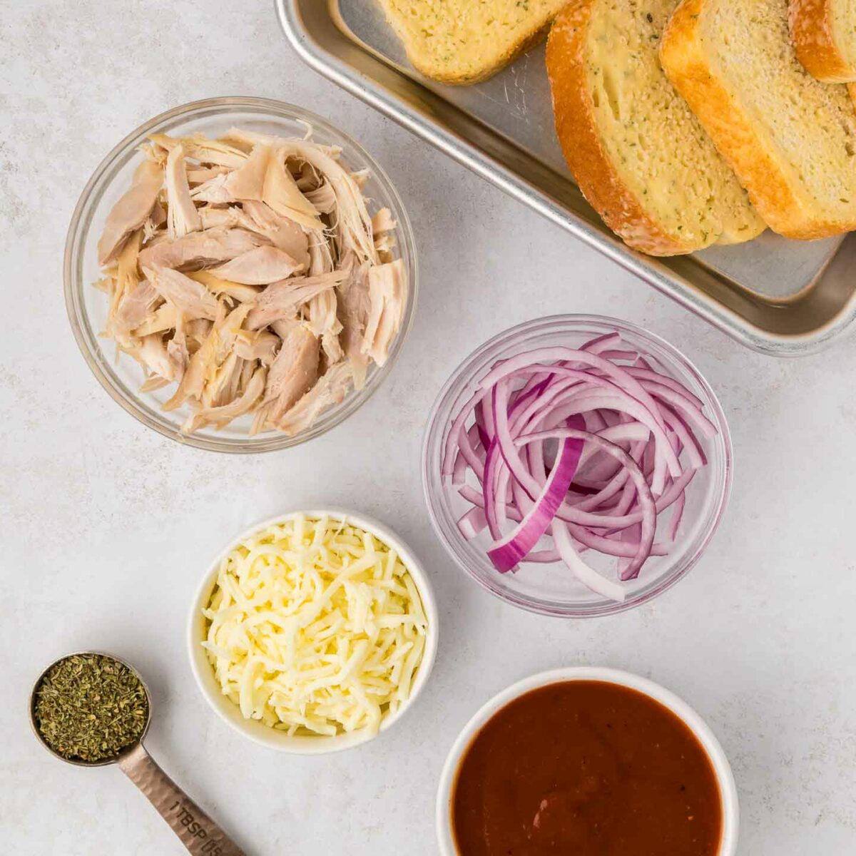 ingredients shown in bowls and on a sheet pan