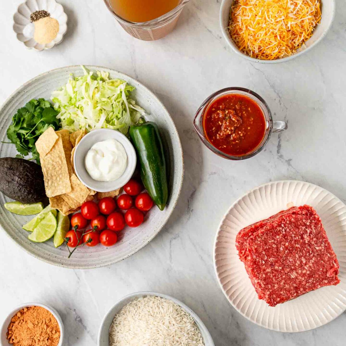 taco rice ingredients shown in white dishes