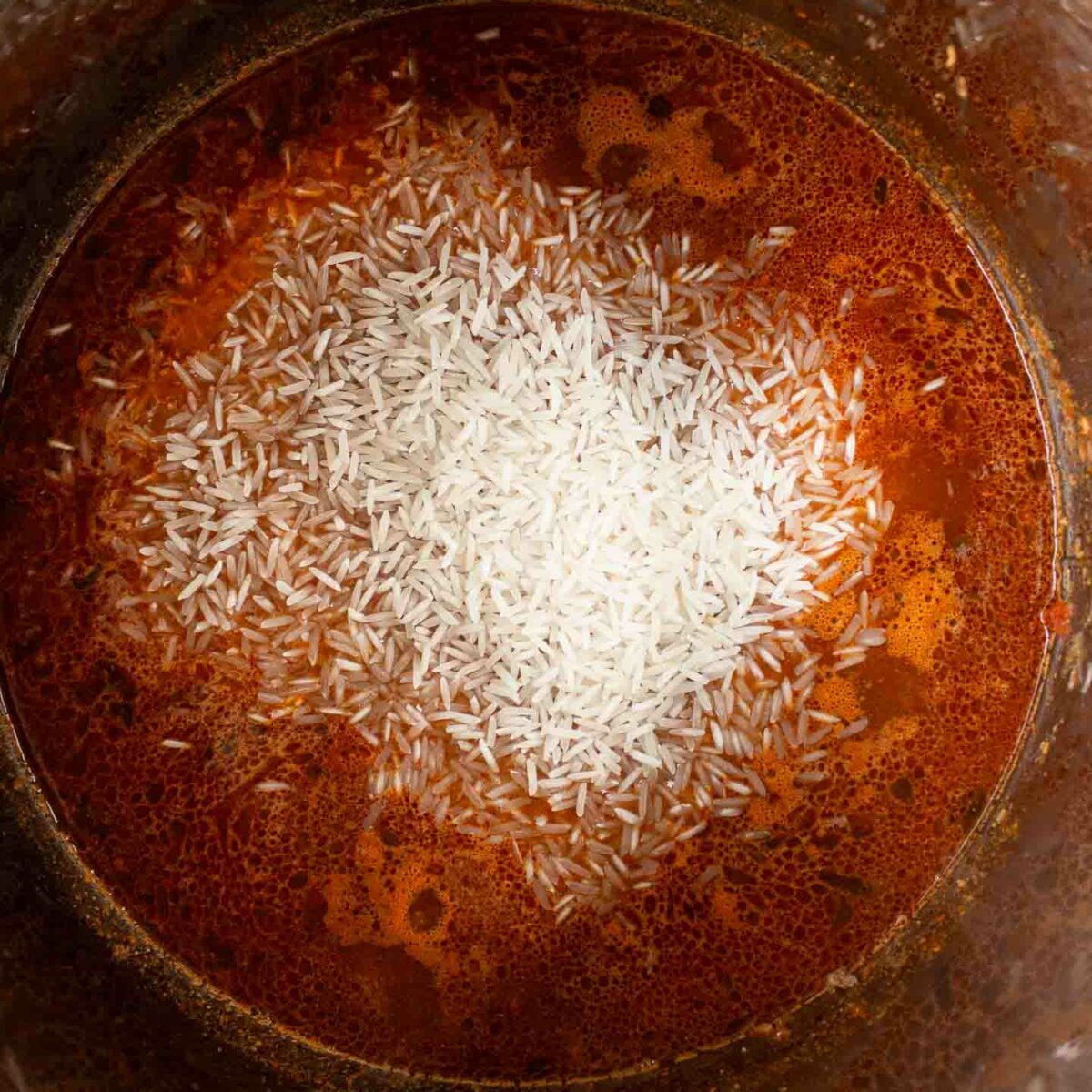 rice shown added in to Instant Pot just before cooking
