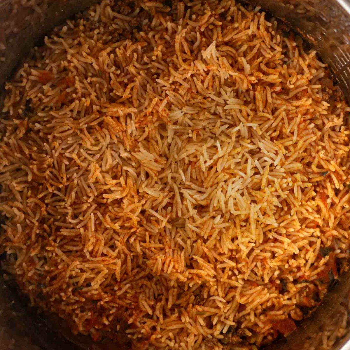 taco rice shown mixed in bottom of Instant Pot