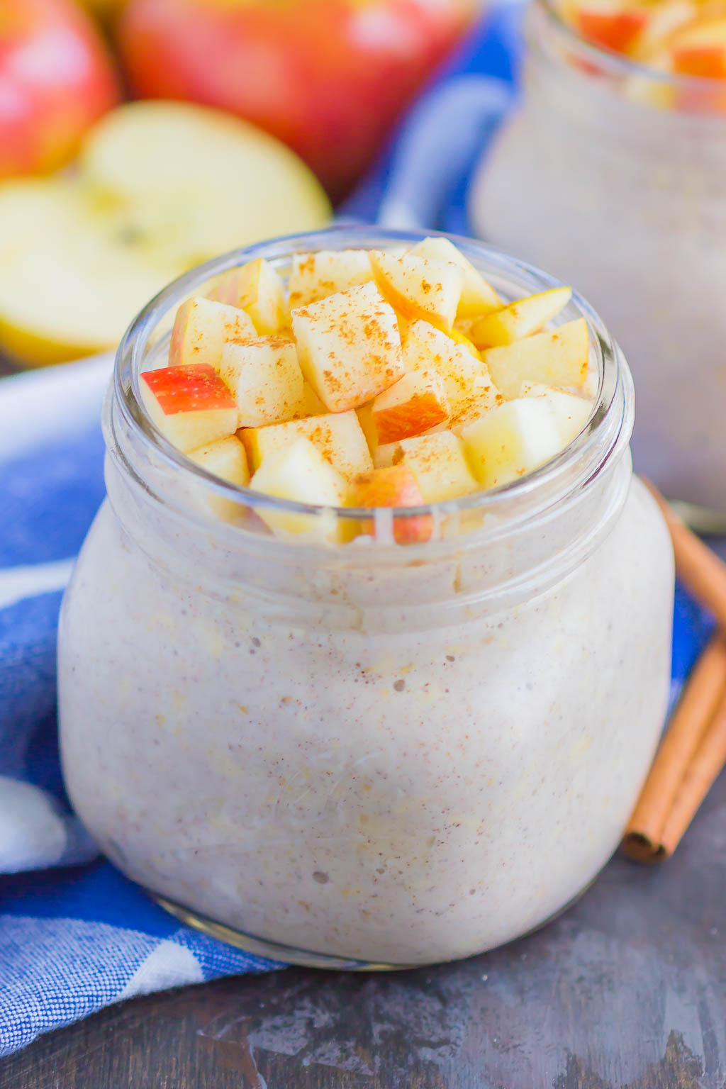 overnight oats in a glass mason jar with diced apples on top