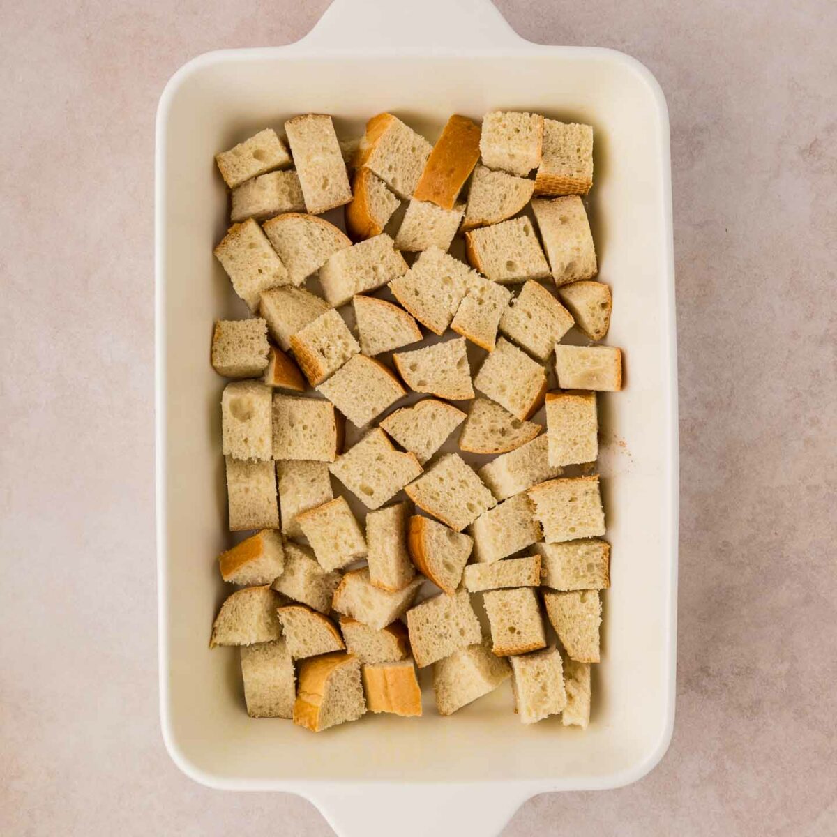 cubed bread on the bottom of casserole dish