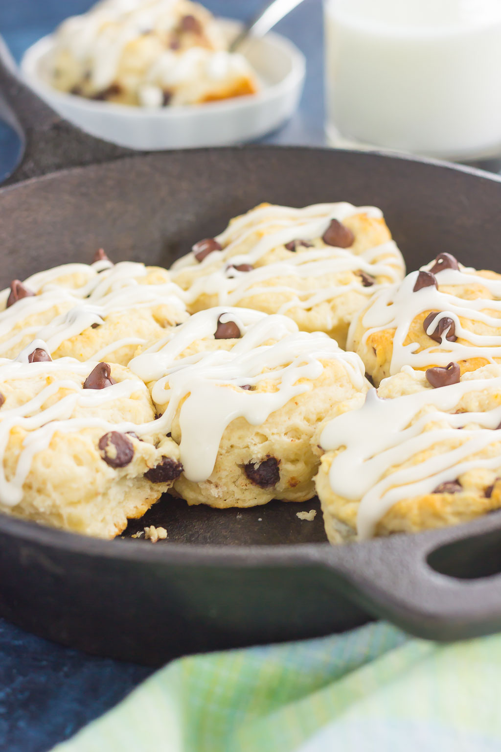 biscuits in a black skillet with one removed