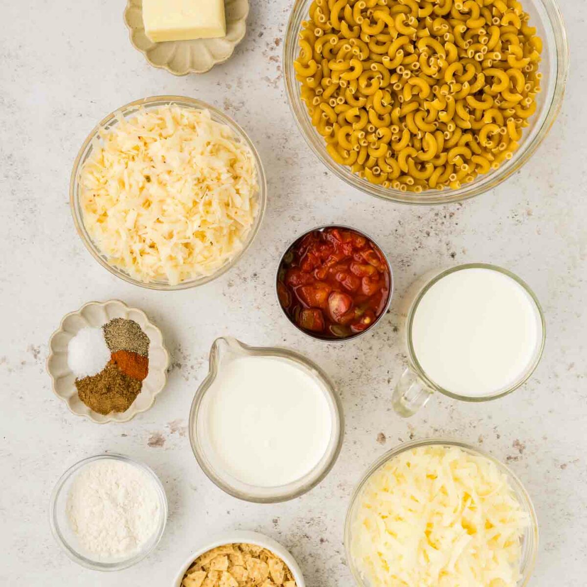 ingredients for mac and cheese shown in bowls