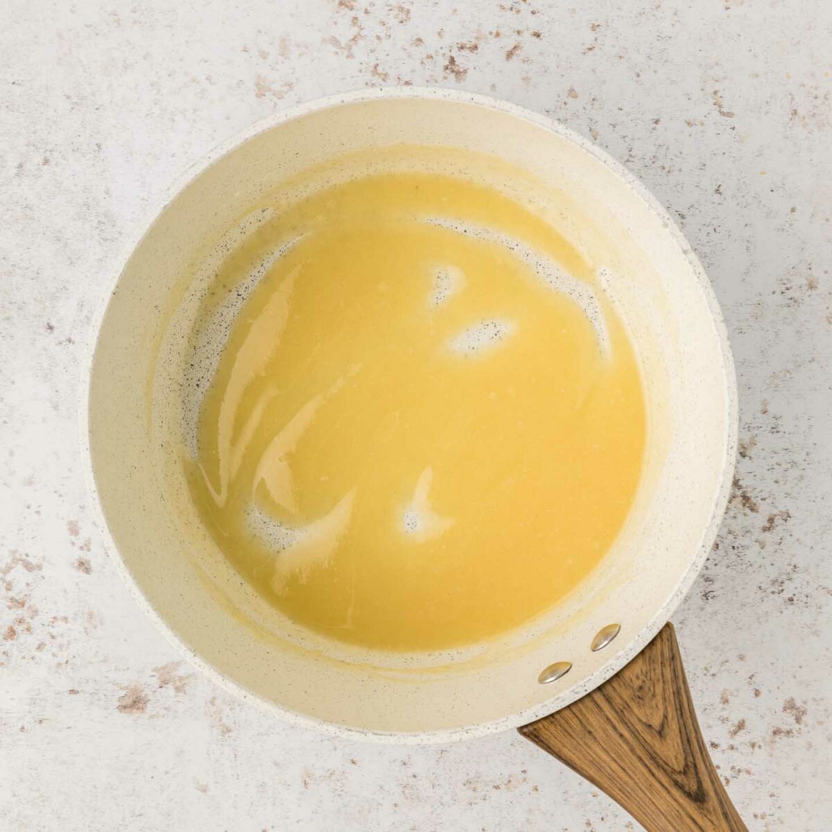 flour roux mixed in white sauce pan