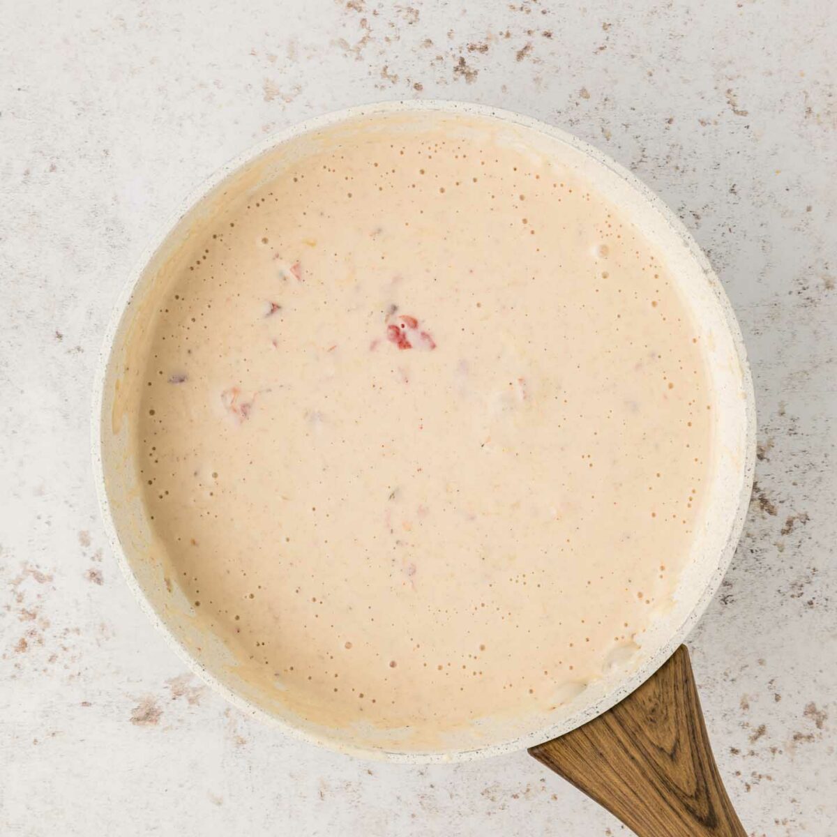 seasonings, shredded cheeses, and rotel added to roux to form a cheese mixture