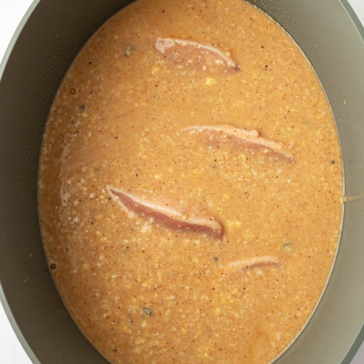 liquid ingredients poured over pork chops in slow cooker