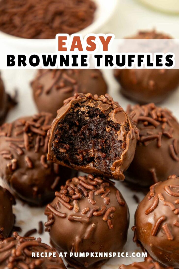 Close-up of several chocolate-covered brownie truffles topped with chocolate sprinkles, one of which has a bite taken out to reveal a rich, fudgy interior. Text reads: Easy Brownie Truffles. Recipe at pumpkinnspice.com.