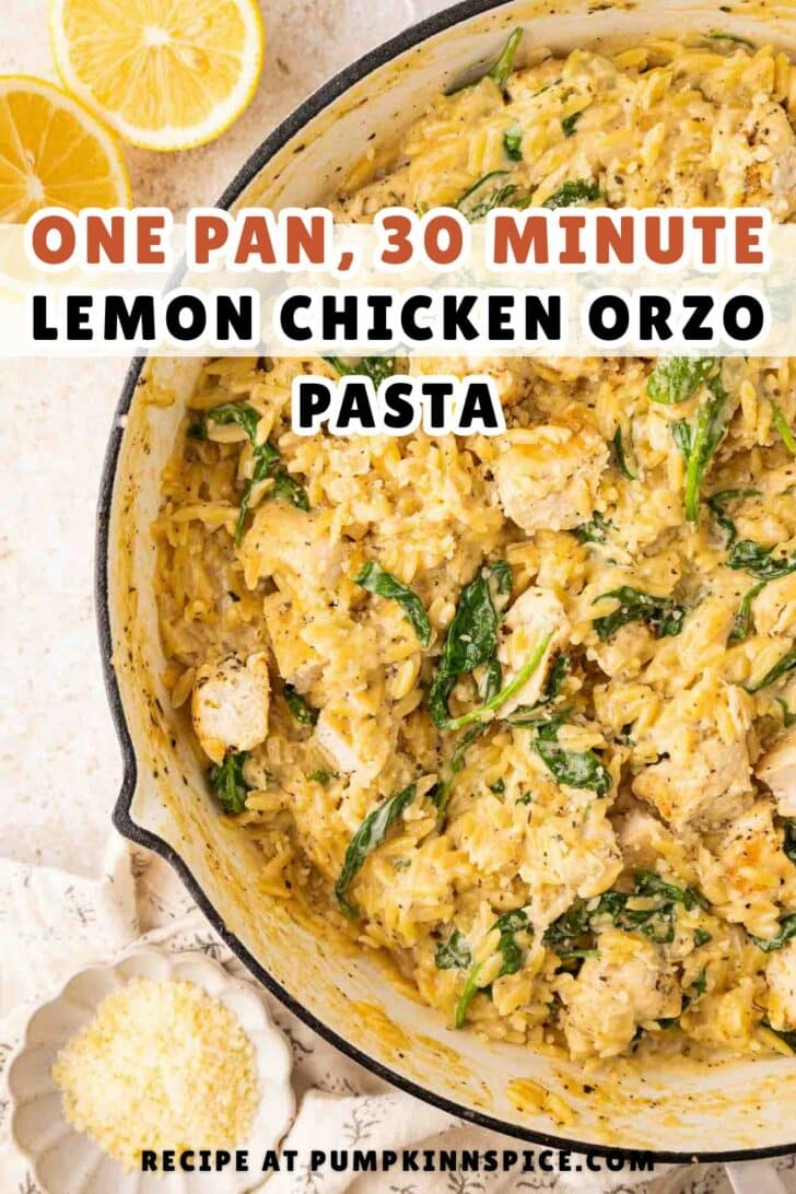 A skillet filled with creamy lemon chicken orzo pasta mixed with spinach, with lemon slices and grated cheese on the side. Text reads: One Pan, 30 Minute Lemon Chicken Orzo Pasta. Recipe at pumpkinnspice.com.