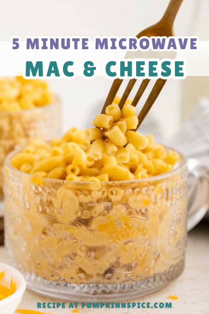 A fork holds up a bite of creamy macaroni and cheese from a decorative glass bowl. Text on the image reads: 5 Minute Microwave Mac & Cheese. Recipe at pumpkininspice.com.
