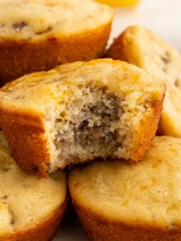 A close-up of mcgriddle muffins on a plate, with one muffin on top showing a bite taken out, revealing its moist, fluffy interior.